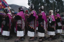 Phujllay yampara independence carnival celebrations.  Line of dancers wearing traditional costume including gallos or spurs attached to their sandals or ojotas.Chuquisaca American Bolivian South Amer...