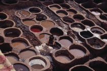 Chouwara Tanneries.  Man working at the tanner s pits.Fez African al-Magrib Fes Moroccan North Africa  Fez African al-Magrib Fes Moroccan North Africa