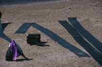 Woman drying dyed cloth on the edge of the Yamuna River.Asia Asian Bharat Inde Indian Intiya  Asia Asian Bharat Inde Indian Intiya