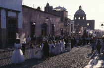 Easter Procession down cobbled street with children dressed in whiteAmerican Kids Mexican Religion Hispanic Latin America Latino Religious American Kids Mexican Religion Hispanic Latin America Latin...