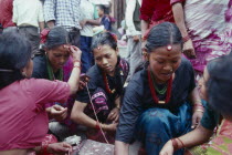 Young women receiving Tikas a mark of blessing on their foreheadAsia Asian Nepalese Religion Religious  Asia Asian Nepalese Religion Religious