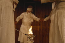 Parsis encircling fire in a temple.  Flames burn eternally in their fire temples and are worshiped as a symbol of their god Ahura Mazda.