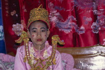 Novice monk ordination with boy in pink and gold costume and face paintAsian Kids Prathet Thai Raja Anachakra Thai Religion Religious Siam Southeast Asia Siamese Asian Kids Prathet Thai Raja Anachak...