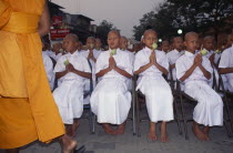 Novice monks holding lotus buds at ordination ceremonyAsian Kids Prathet Thai Raja Anachakra Thai Religion Siam Southeast Asia Religious Siamese Asian Kids Prathet Thai Raja Anachakra Thai Religion...