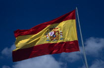 Alicante.  Spanish flag flying against blue sky and white clouds.Espainia Espana Espanha Espanya European Hispanic Southern Europe