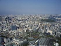 Cityscape from Tokyo Tower with high rise buildings  car park  sports courts and building site.Asia Asian Automobile Automotive Cars Gray Japanese Motorcar Nihon Nippon Automobiles Automvil Autos Gr...