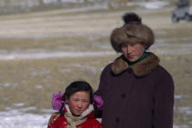 Portrait of Kazakh woman and her daughter watching the horse races. Asia Asian Equestrian Kids Mongol Uls Mongolian Female Women Girl Lady Female Woman Girl Lady