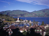 View over roof tops towards Spiez Village and south bank of Lake Thunersee with yachts on the waterEuropean Schweiz Suisse Svizzera Swiss Western Europe Scenic