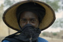 Portrait of a Fulani woman wearing a hat with a scarfe covering her mouth.African Bororo Female Woman Girl Lady Female Women Girl Lady Fulbe Nigerian Peul Western Africa