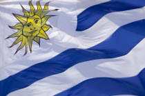 Close-up of the national flag of Uruguay.TravelSouth AmericaLatin America. EmblemSunBlueUruguayFlagAmerican Hispanic Latino