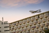 Eivissa. Charter flight coming into land at Ibiza airport  Aeroport dEivissa  with tourist hotel in the foreground.Jon Hicks.TourismHolidaysMediterraneanBalearic IslandsTravelLeisureSpainEuro...