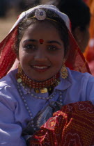 Portrait of a young girl dancer smiling wearing traditional dress and jewellery before the start of the Shekhawati FestivalAsia Asian Nepalese Bharat Inde Indian Intiya Male Men Guy Male Man Guy Reli...