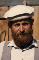 Head and shoulders portrait of a man with a beard wearing a hat in the bazaar in ChitralAsia Asian Nepalese Male Men Guy Male Man Guy Pakistani One individual Solo Lone Solitary