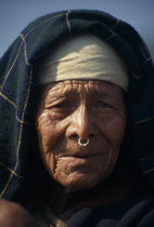 Head and shoulders portrait of elderly woman wearing a nose ring in Maachhim Village.