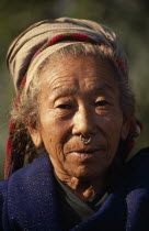 Head and shoulders portrait of elderly woman wearing a nose ring in Palati Village near the Arun River valleyAsia Asian Nepalese Female Women Girl Lady Old Senior Aged Female Woman Girl Lady One indi...