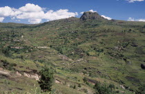 Near Antsirabe. Terraced paddy fields and homes set into hillside African Eastern Africa Madagascaran Madagasikara Scenic Farming Agraian Agricultural Growing Husbandry  Land Producing Raising