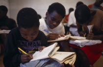 Schoolchildren writing in exercise books.