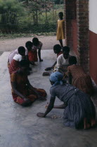 Tutsi children playing game with stones.