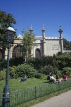 Brighton Museum and Art Gallery seen from The Royal Pavilion gardens with families sitting on the grass European Great Britain Northern Europe UK United Kingdom British Isles Pavillion