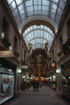 Exchange Arcade interior decorated at Christmas with people shoppingEuropean Great Britain Northern Europe UK United Kingdom Xmas British Isles