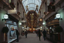 Exchange Arcade interior decorated at Christmas with people shoppingEuropean Great Britain Northern Europe UK United Kingdom Xmas British Isles