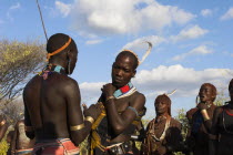 HamerJumping of the Bulls initiation ceremony  Hamer men chat whilst women perform ritual dancing around bulls