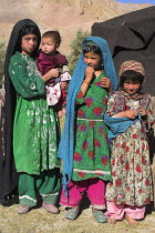 Aimaq nomad camp  Aimaq girls and baby in front of yurt   The Aimaq are semi nomadic people who move out of their mud house villages after spring and live in yurts to tend their flocks before moving b...