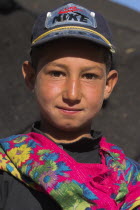 Aimaq nomad camp  Aimaq boy wearing colourful scarf   The Aimaq are semi nomadic people who move out of their mud house villages after spring and live in yurts to tend their flocks before moving back...