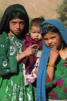 Aimaq nomad camp  Aimaq girls and baby in front of yurt   The Aimaq are semi nomadic people who move out of their mud house villages after spring and live in yurts to tend their flocks before moving b...