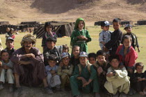 Aimaq nomad camp  Aimaq man with children   The Aimaq are semi nomadic people who move out of their mud house villages after spring and live in yurts to tend their flocks before moving back to their h...