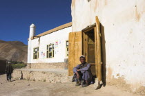 Man sitting in doorway of mosqu