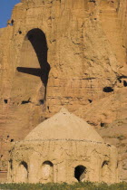 Tomb near empty niche where the famous carved Budda once stood  destroyed by the Taliban in 2001