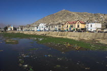 Shah -do-Shamshira Mosque and shops line the banks of the polluted Kabul river