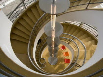 The De La Warr Pavilion. Interior view down the helix staircase with chrome Bauhaus globe lamps. Three colourful chairs seen at the bottomEuropean Great Britain Northern Europe UK United Kingdom Brit...