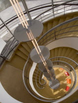 The De La Warr Pavilion. Interior view down the helix staircase with chrome Bauhaus globe lamps. Three colourful chairs seen at the bottomEuropean Great Britain Northern Europe UK United Kingdom Brit...