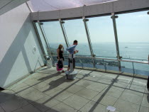 Gunwharf Quay, The Spinnaker Tower. Interior view with visitors looking out of glass windows on the top observation deck  providing a 320¡ view of the city of Portsmouth  the Langstone and Portsmouth...