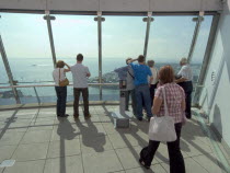 Gunwharf Quay, The Spinnaker Tower. Interior view with visitors looking out of glass windows on the top observation deck  providing a 320¡ view of the city of Portsmouth  the Langstone and Portsmouth...