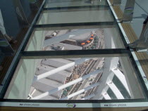 Gunwharf Quay, The Spinnaker Tower. Interior view looking down from observation deck through glass window towards the base of the tower over waterfront restaurants and shops.