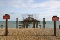 Ruins of the West Pier with warning signs.European Great Britain Northern Europe UK United Kingdom