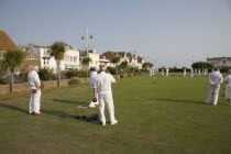 Men playing a game of bowls on green