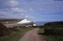 The Seven Sisters white chalk cliffs viewed from a path at Seaford Head