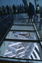 Gunwharf Quay, The Spinnaker Tower. Interior at top of tower with a glass floor window  looking down.Visitors looking out glass windows on the observation deck providing a 320¡ view of the city of Po...