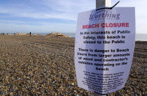 Timber washed up on the beach from the Greek registered Ice Princess which sank off the Dorset coast on 15th January 2008. A sign warns people to keep off the beach which they ignore