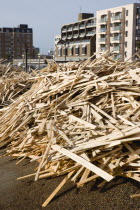 Timber washed up on the beach from the Greek registered Ice Princess which sank off the Dorset coast on 15th January 2008. Seafront flats beyond on the promenade