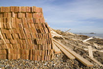 Timber washed up on the beach from the Greek registered Ice Princess which sank off the Dorset coast on 15th January 2008. Worthing Pier in the distance