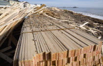 Timber washed up on the beach from the Greek registered Ice Princess which sank off the Dorset coast on 15th January 2008. Worthing Pier in the distance