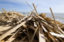 Timber washed up on the beach from the Greek registered Ice Princess which sank off the Dorset coast on 15th January 2008. Worthin Pier in the distance