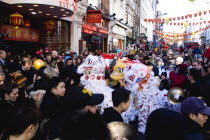 Lion Dance troupe performing in Wardour Street with onlooking crowd during Chinese New Year celebrations in 2006 for the coming Year of The Dog