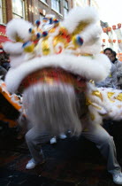 Lion Dance troupe performing in Gerrard Street with onlooking crowd during Chinese New Year celebrations in 2006 for the coming Year of The Dog