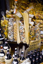 ITALY, Tuscany, San Gimignano, Shop display of a variety of colourful pastas and Chianti wines.